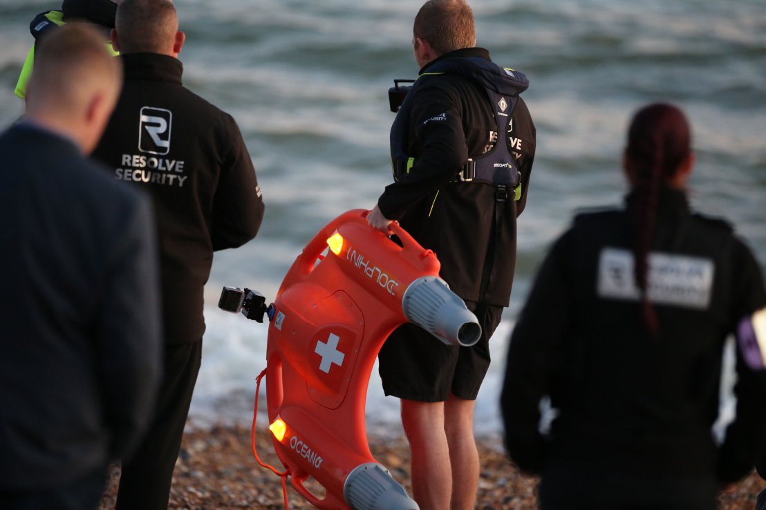 water rescue team applys remote control lifebuoy on a beach