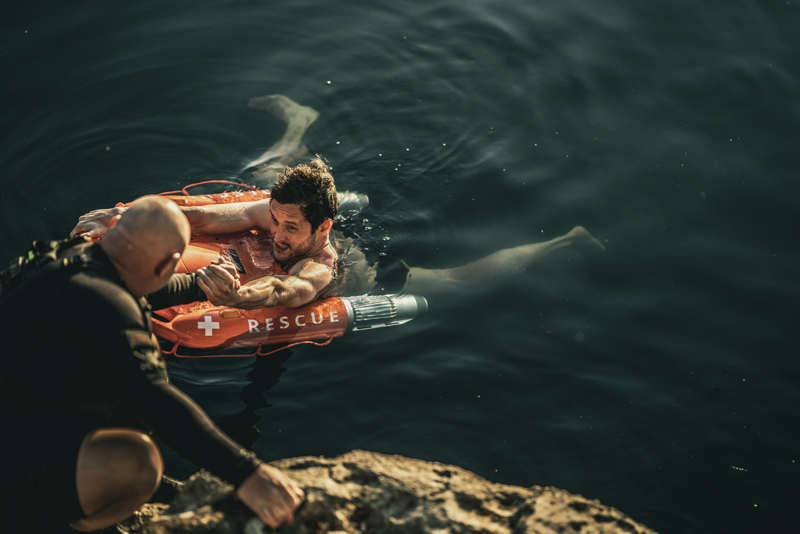 man floating on a remote control lifebuoy