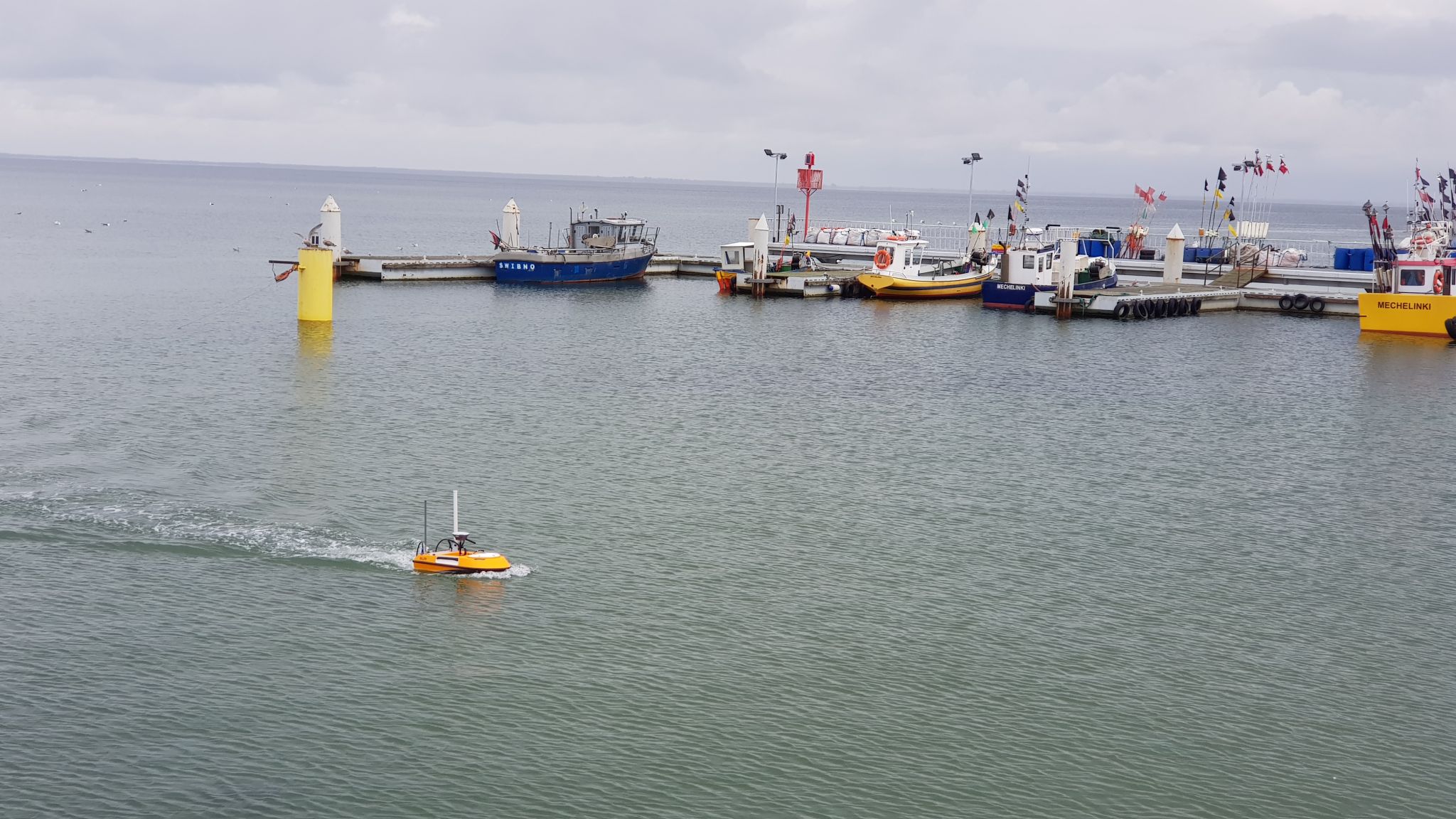 SL20 unmanned surface vehicle sailing near a dock