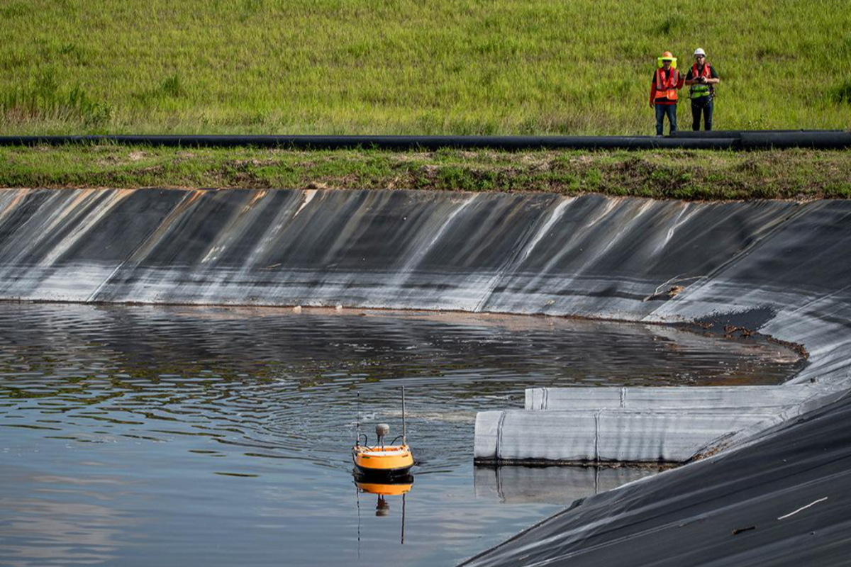 The lightweight SL20 USV with a carbon-fiber hull being deployed for a bathymetric survey in a narrow river.